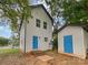 Two-story house with a blue door and a detached shed at 103 Pleasant Hill St, Lancaster, SC 29720