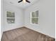 Bright bedroom with neutral carpeting and two large windows at 103 Pleasant Hill St, Lancaster, SC 29720