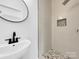 Modern bathroom with pebble-textured shower floor and sleek fixtures at 103 Pleasant Hill St, Lancaster, SC 29720
