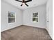 Simple bedroom with neutral carpeting and two large windows at 103 Pleasant Hill St, Lancaster, SC 29720
