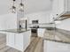Modern kitchen with white cabinets, granite countertops, and an island at 103 Pleasant Hill St, Lancaster, SC 29720