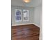 Bedroom with hardwood floors and two windows overlooking trees at 3739 Innes Ln, Maiden, NC 28650