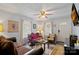 Living room with hardwood floors, antique furniture, and large windows at 900 Alma Ave, Kannapolis, NC 28081