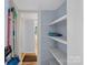 View of a narrow hallway with storage shelves at 900 Alma Ave, Kannapolis, NC 28081