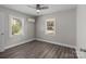 Bright bedroom with hardwood floors, ceiling fan, and two windows at 2208 S Ridge Ave, Kannapolis, NC 28023