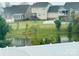 Community lake view with houses in the background at 229 Lake George Dr, Shelby, NC 28152