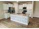 Modern kitchen with white cabinets, granite island, and stainless steel appliances at 229 Lake George Dr, Shelby, NC 28152