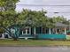 Teal house with a wraparound porch and mature tree at 240 Bost St, Statesville, NC 28677