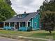 Charming teal home with a spacious front porch and well-maintained lawn at 240 Bost St, Statesville, NC 28677