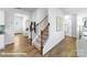 Staircase with hardwood floors and black metal railings in the entry at 123 Woodhall Way, Troutman, NC 28166