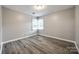 Well-lit bedroom featuring neutral walls and vinyl flooring at 9116 Old Barnette Pl, Huntersville, NC 28078