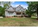 Two story home with gray siding, brick accents, and a large front yard at 1668 Cunningham Dr, Rock Hill, SC 29732