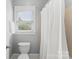 Bathroom with shower/tub combo, toilet, and window at 1668 Cunningham Dr, Rock Hill, SC 29732