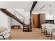 Modern staircase with glass and wood railings, near kitchen and dining areas at 237 Marsh Rd # 101, Charlotte, NC 28209