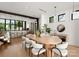 Open concept dining room with a large wooden table and modern white chairs at 237 Marsh Rd # 101, Charlotte, NC 28209