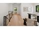 Modern hallway with hardwood floors and stylish artwork at 237 Marsh Rd # 101, Charlotte, NC 28209