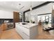 Modern kitchen with a large island, stainless steel appliances, and wood cabinets at 237 Marsh Rd # 101, Charlotte, NC 28209