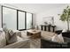 Modern living room with large windows, comfortable seating, and stylish decor at 237 Marsh Rd # 101, Charlotte, NC 28209