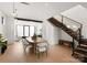 Modern dining room with an oval wooden table and white chairs, near a staircase at 237 Marsh Rd # 101, Charlotte, NC 28209