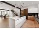 Modern kitchen island with white quartz countertops and a built-in cooktop at 237 Marsh Rd # 101, Charlotte, NC 28209