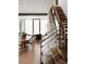 Modern staircase with glass and wood accents, overlooking dining area at 237 Marsh Rd # 101, Charlotte, NC 28209