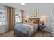 Guest bedroom with striped bedding and wood frame bed at 5010 Sunbriar Dr # 00200, Charlotte, NC 28216