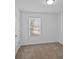 Spacious bedroom with neutral carpeting and large window at 5010 Sunbriar Dr # 00200, Charlotte, NC 28216