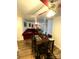 Open dining area with a wooden table and red sectional sofa at 4821 Spring Lake Dr # C, Charlotte, NC 28212