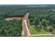 Aerial view of a new road development with wooded area at 1029 Baylor Grv, Monroe, NC 28110