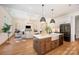 Modern kitchen with island, white cabinets, and stainless steel appliances at 1029 Baylor Grv, Monroe, NC 28110