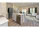 Open concept kitchen with island and stainless steel appliances at 1253 Falling Acorn Ln, Concord, NC 28027