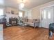 Living room featuring hardwood floors, fireplace, and large windows at 3025 Rush Ave, Charlotte, NC 28208