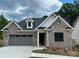 Brick home with gray two-car garage and landscaping at 1 Beth Haven Church Rd, Denver, NC 28037
