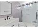 Modern bathroom with gray herringbone tile, glass shower, and white vanity at 3392 Brackhill St, Davidson, NC 28036