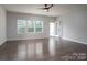 Bright living room with hardwood floors, ceiling fan, and access to a patio at 162 Old Harbor Dr, Mount Gilead, NC 27306