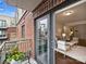 Outdoor balcony with brick wall and view into living room at 721 Governor Morrison St # 526, Charlotte, NC 28211