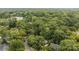 An aerial view showcasing a home surrounded by lush green trees and other houses at 4820 Montclair Ave, Charlotte, NC 28211