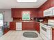 Kitchen with red cabinets, white appliances, and a window overlooking backyard at 11214 Sudbury Rd, Davidson, NC 28036