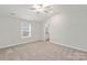 Spacious bedroom with carpeted floors and ceiling fan at 118 Brixham Loop, Troutman, NC 28166