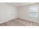 Bedroom with double doors leading to closet and window with blinds at 118 Brixham Loop, Troutman, NC 28166