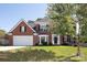 Two-story brick home with a large front yard and attached garage at 1245 Blackstone Ct, Concord, NC 28027