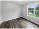 Well-lit bedroom with hardwood floors and a window with backyard view at 819 Brooklee Dr, Kings Mountain, NC 28086