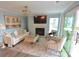 Elegant living room featuring fireplace and water views at 18867 Vineyard Point Ln, Cornelius, NC 28031