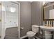 Stylish bathroom with black and white striped wallpaper, pedestal sink, and toilet at 702 Forest Hill Dr, Shelby, NC 28150