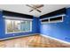 Blue bedroom with wood flooring, window, and ceiling fan at 702 Forest Hill Dr, Shelby, NC 28150