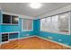 Bedroom with blue walls, wood floors, and built-in desk at 702 Forest Hill Dr, Shelby, NC 28150