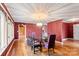 Bright dining room features hardwood floors and a glass table with plaid chairs at 702 Forest Hill Dr, Shelby, NC 28150