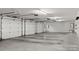 Bright three-car garage featuring automatic garage doors and storage shelves at 702 Forest Hill Dr, Shelby, NC 28150