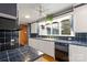 Kitchen with white cabinets, blue tile countertops, and a view to the backyard at 702 Forest Hill Dr, Shelby, NC 28150