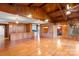 Open living room with wood-paneled walls, hardwood floors, and a view into the kitchen at 702 Forest Hill Dr, Shelby, NC 28150